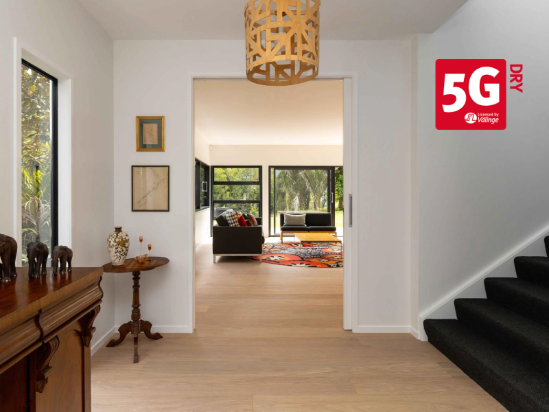 Light-toned wood flooring in modern dining space demonstrating clean, moisture-resistant finish