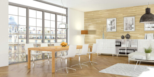 Bright and modern dining area with a wooden table, white chairs, large windows, and stylish decor against a wooden accent wall.