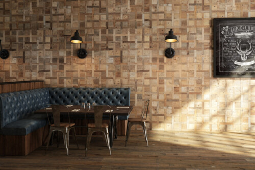 A stylish restaurant interior featuring wooden walls, upholstered seating, and a rustic table setting illuminated by wall lamps.